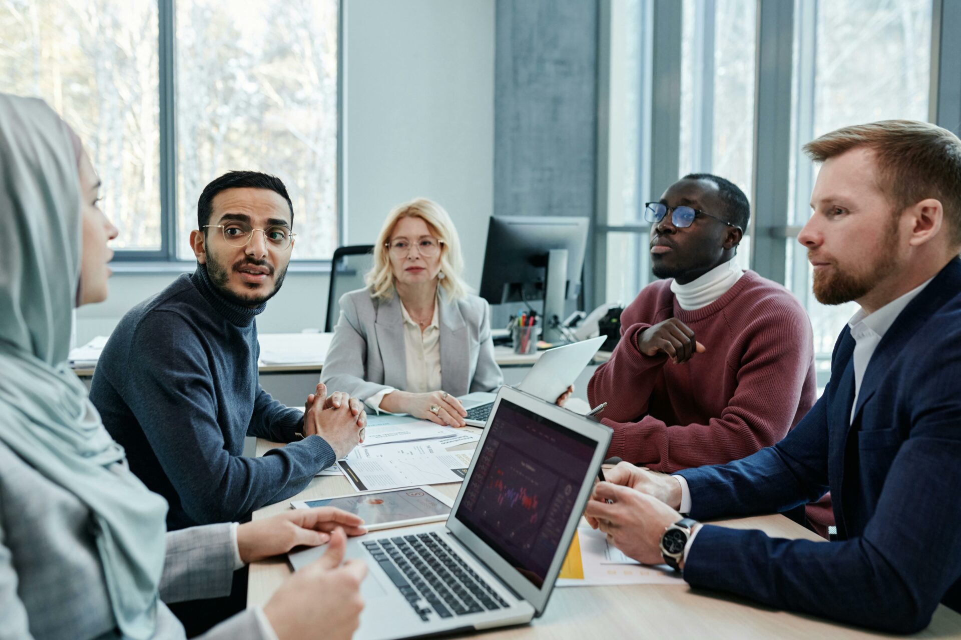 Photo shows a diverse group of coworkers in a meeting